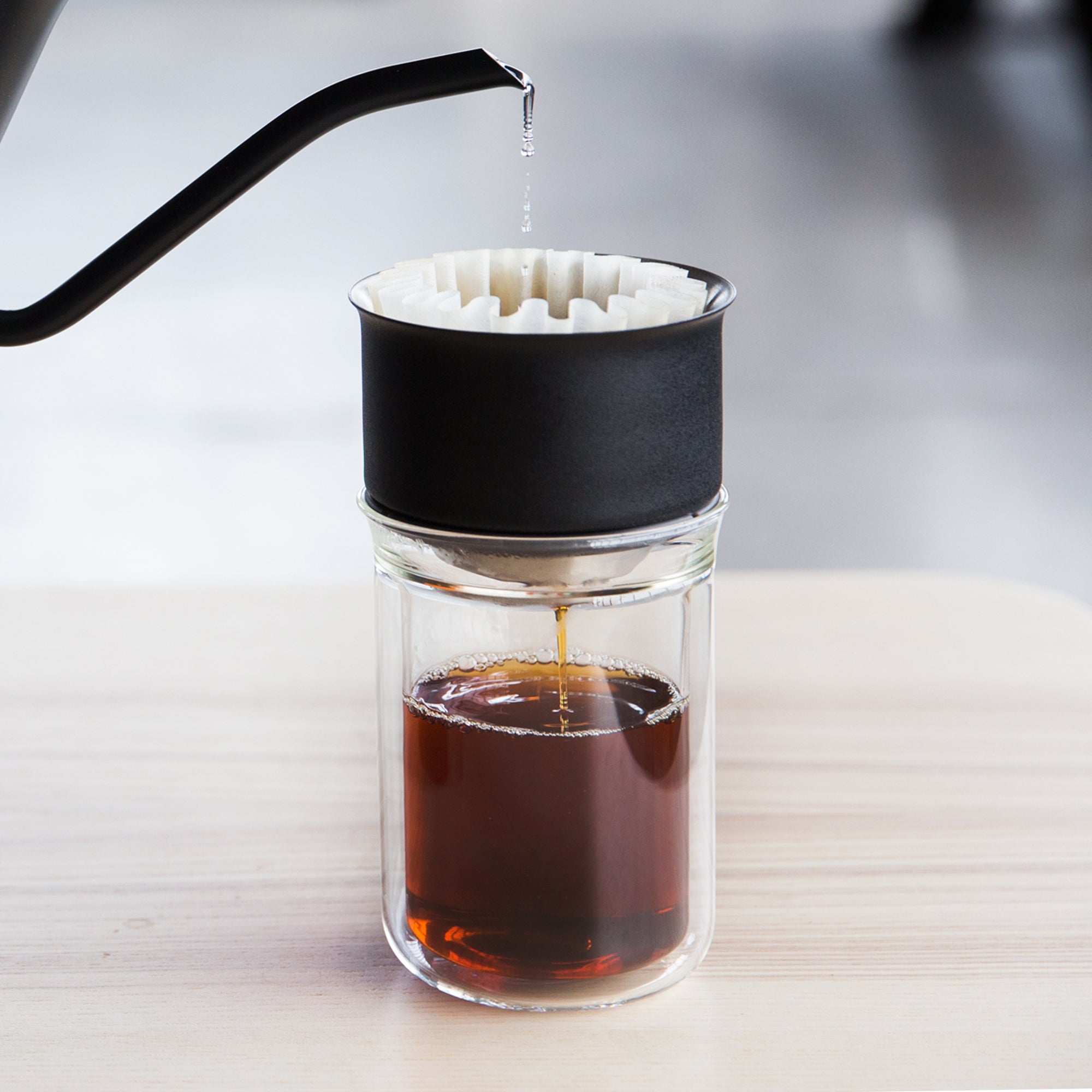 Stagg EKG brewing coffee into Stagg [X] Dripper over a Stagg Tasting Glass